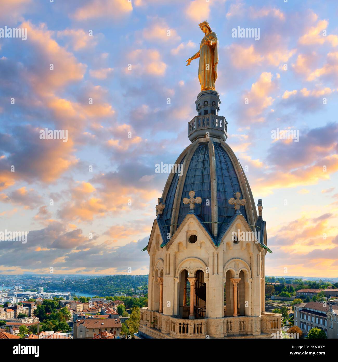 View of famous Marie statue on top of Notre-dame-de-fourviere basilica in Lyon at sunset, France Stock Photo