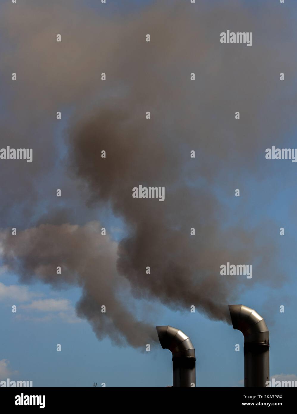 two chimneys from which black smoke comes out, pollution, toxic Stock