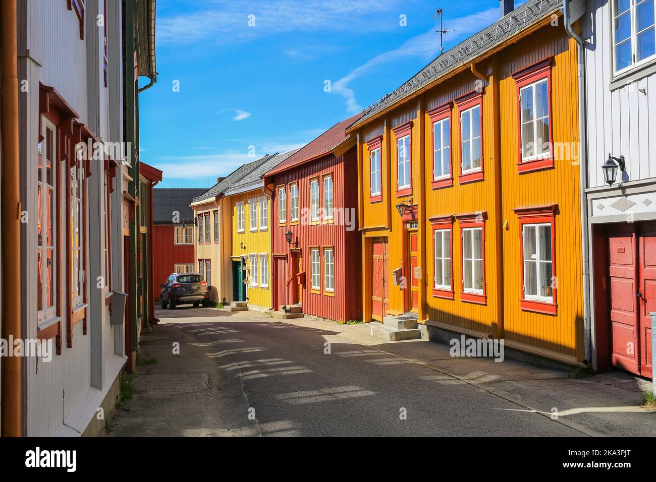 Street with colorful timber houses in Roeros. Roeros  is a municipality in Trøndelag county, Norway and also the mining town . Stock Photo