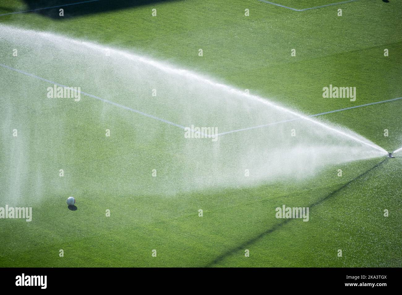 Overhead view of sprinklers watering a football pitch, Spain Stock