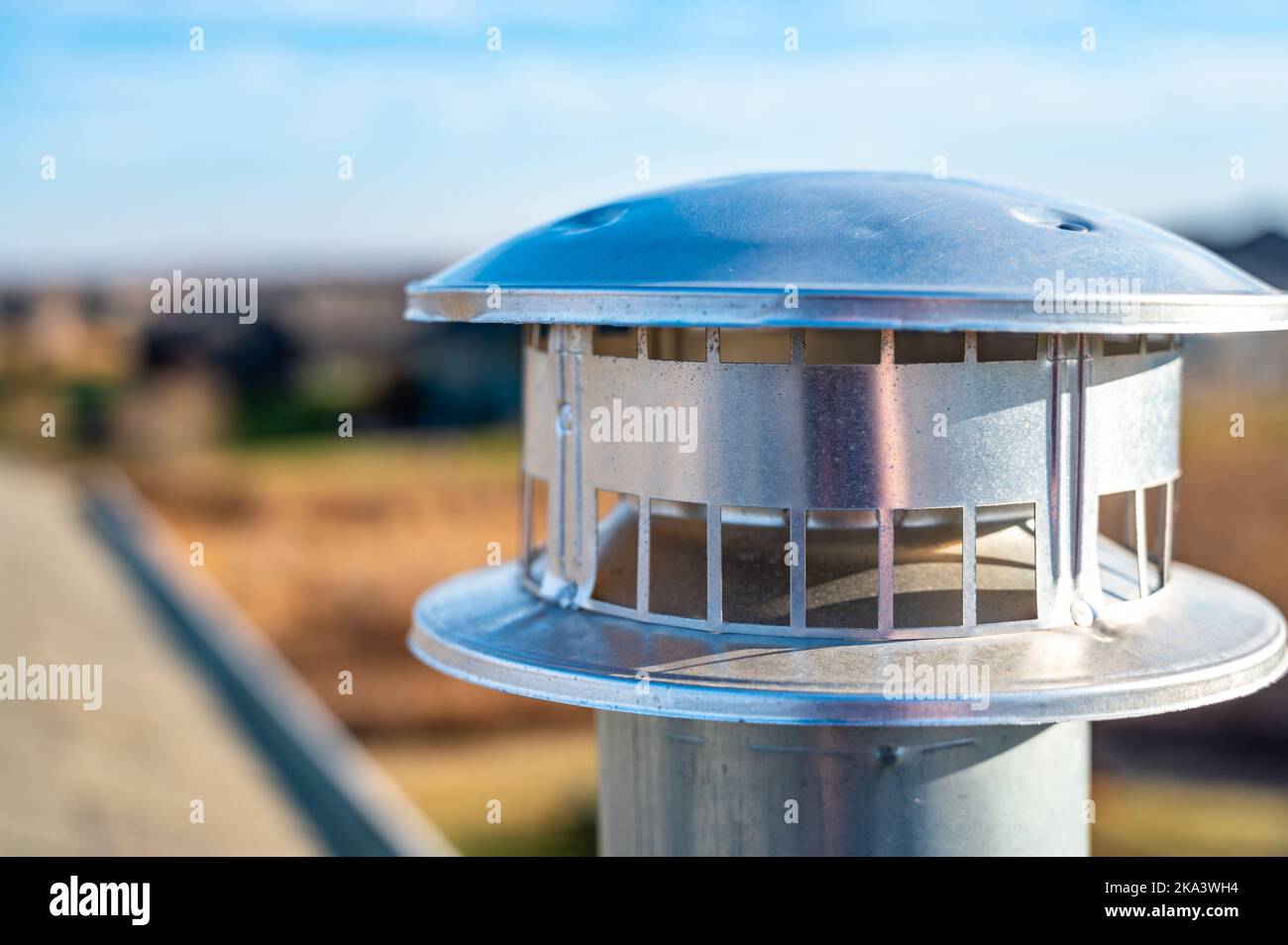 side view of a Galvanized metal chimney exhaust on asphalt roof with a rain cap Stock Photo Alamy