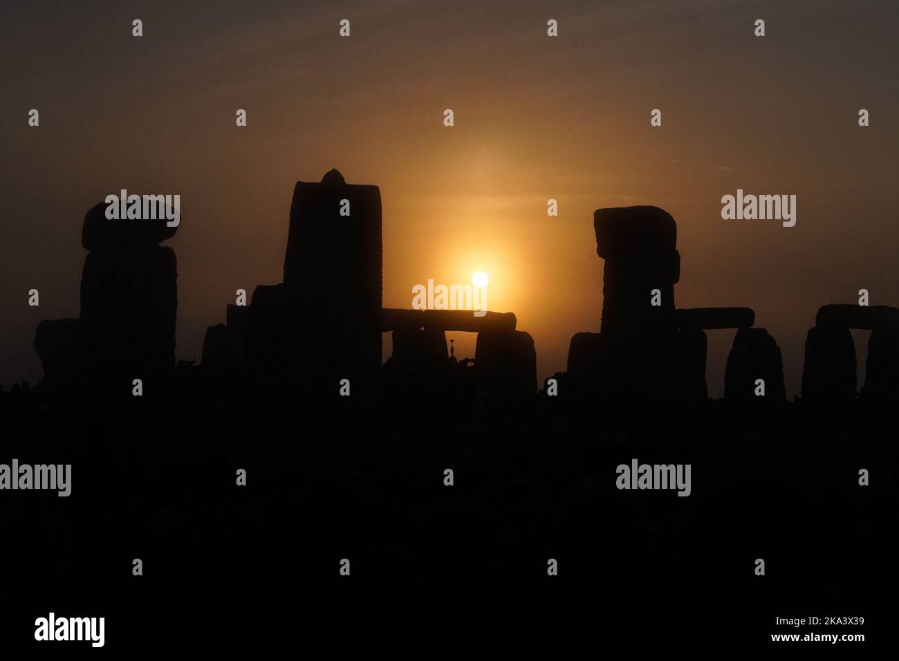 People from around the world descend on western England to celebrate the summer solstice with the rising of the sun at Stonehenge. Stonehenge is a pre-historic monument on the Salisbury Plain of England. Archaeologists believe this UNESCO World Heritage Site to have begun construction in 3100BC. Stock Photo