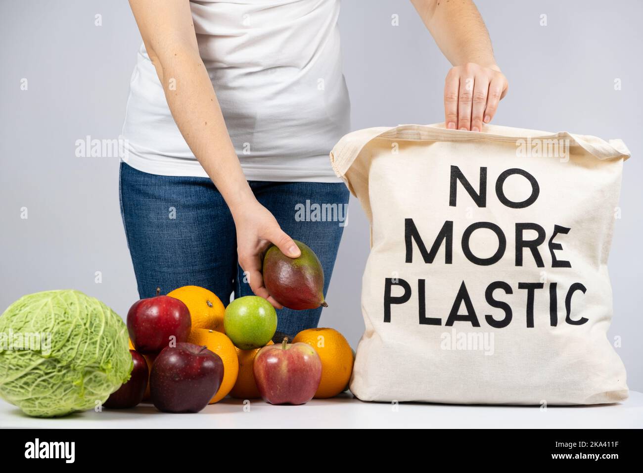 A woman puts products in a fabric eco bag with no more plastic. The