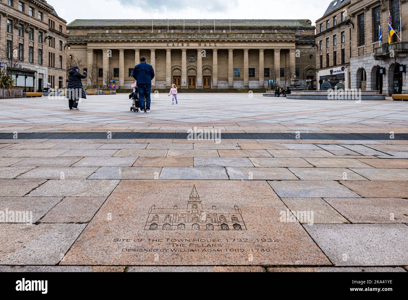 Caird Hall concert venue with William Adam flagstone inscription and child running in square, Dundee city centre, Scotland, UK Stock Photo