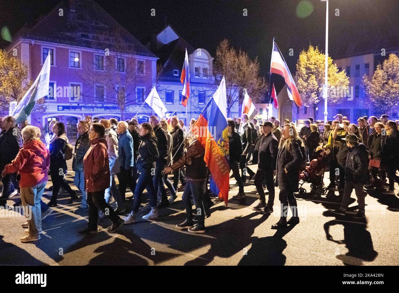 Bautzen, Germany. 31st Oct, 2022. Participants of a demonstration walk across the Kornmarkt with various flags, including a Russian national flag. Credit: Sebastian Kahnert/dpa/Alamy Live News Stock Photo