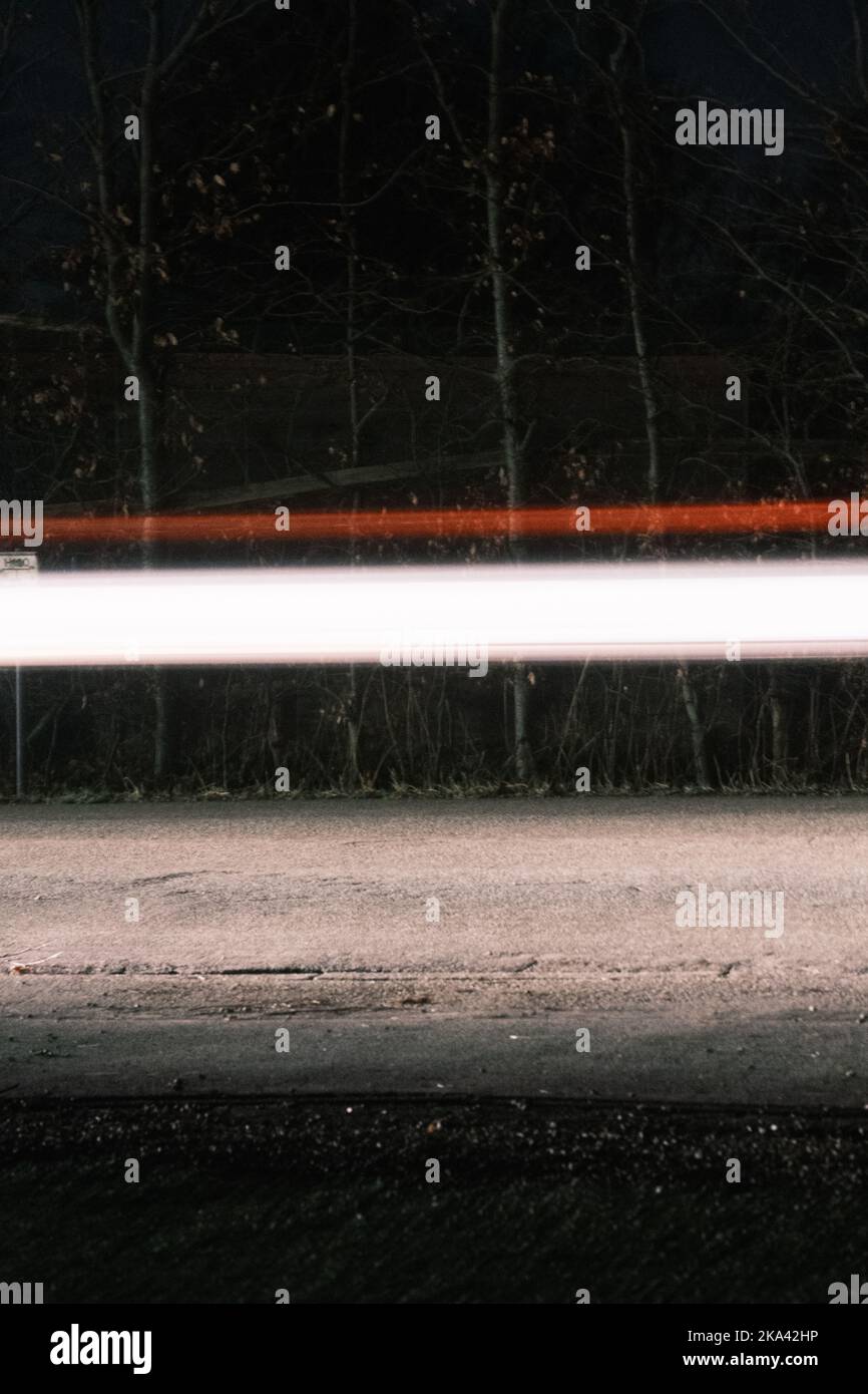 A vertical shot of car trails with long exposure on the road Stock ...