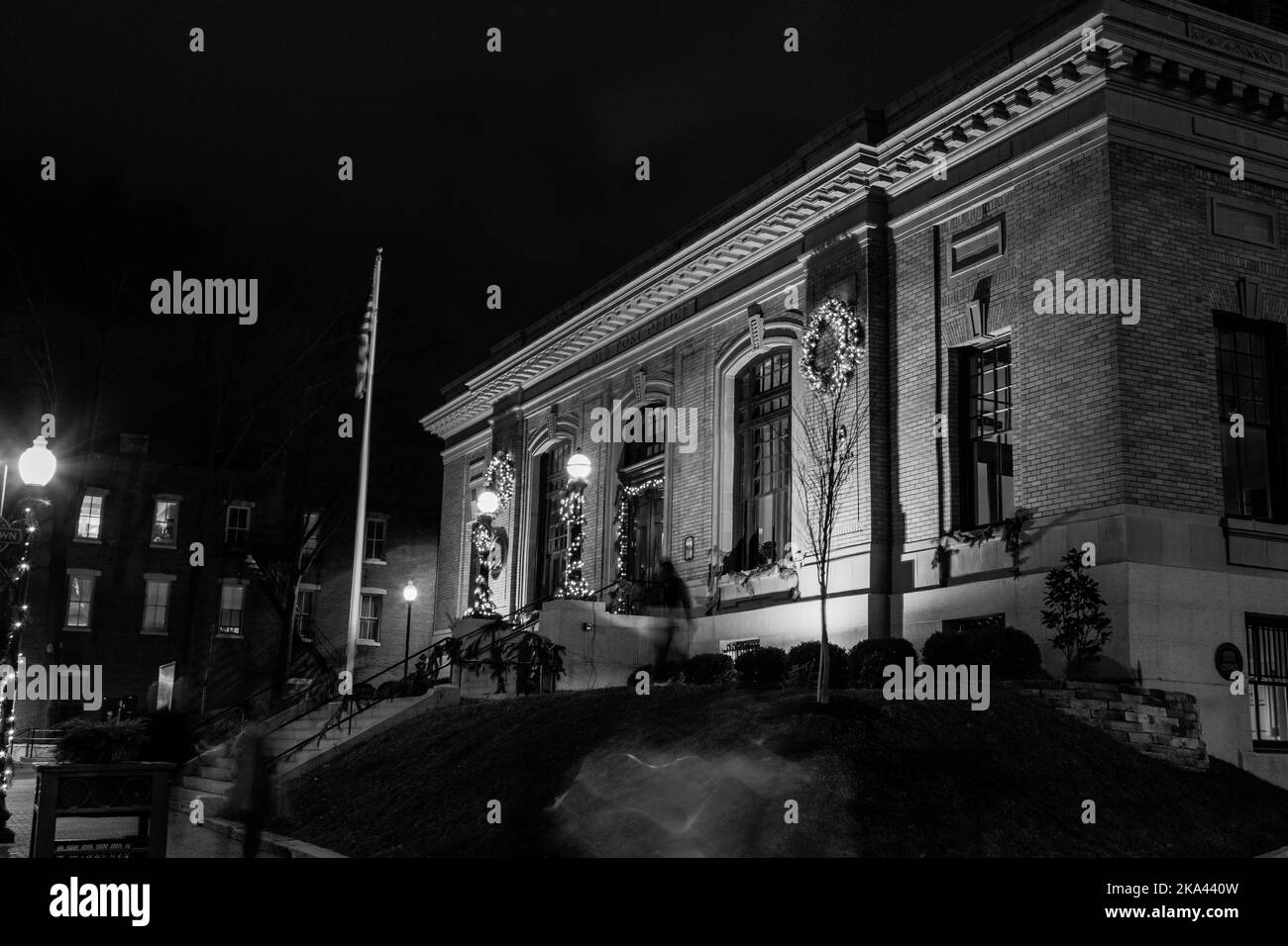 A black and white shot of a building at night Stock Photo