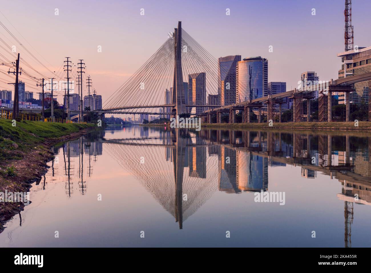View of Pinheiros River With Modern Buildings Alongside and Famous Octavio Frias de Oliveira Bridge in Sao Paulo City Stock Photo