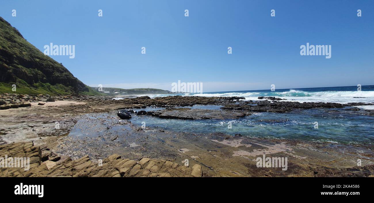 A natural view of waves hitting the rocky shore of South Africa Stock ...