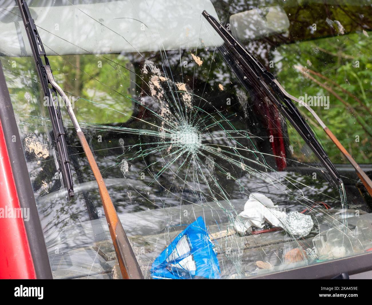 broken windscreen on a old van with worn and rusty windscreen wipers Stock Photo