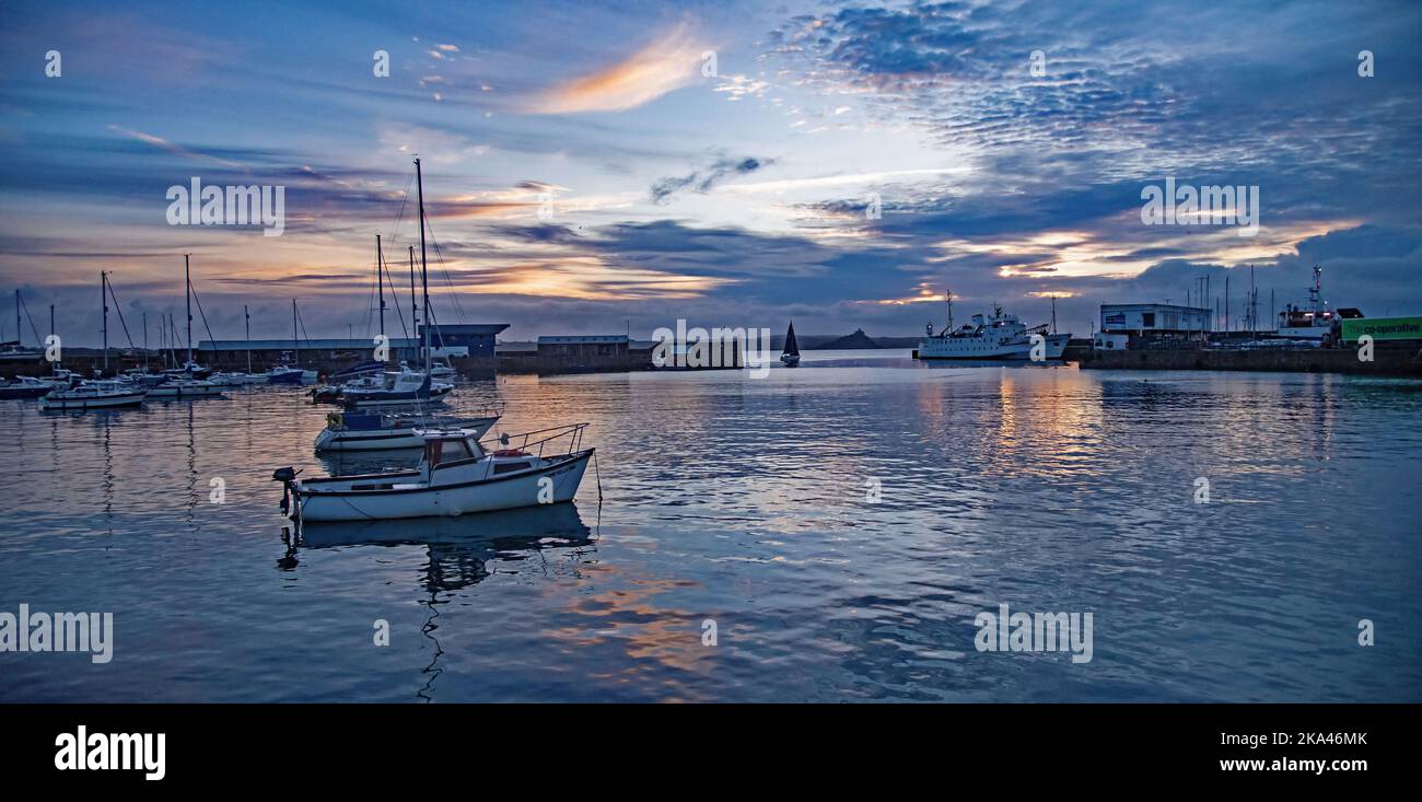 Mood reflections captured  at Penzance Harbour Cornwall at sun rise. Stock Photo