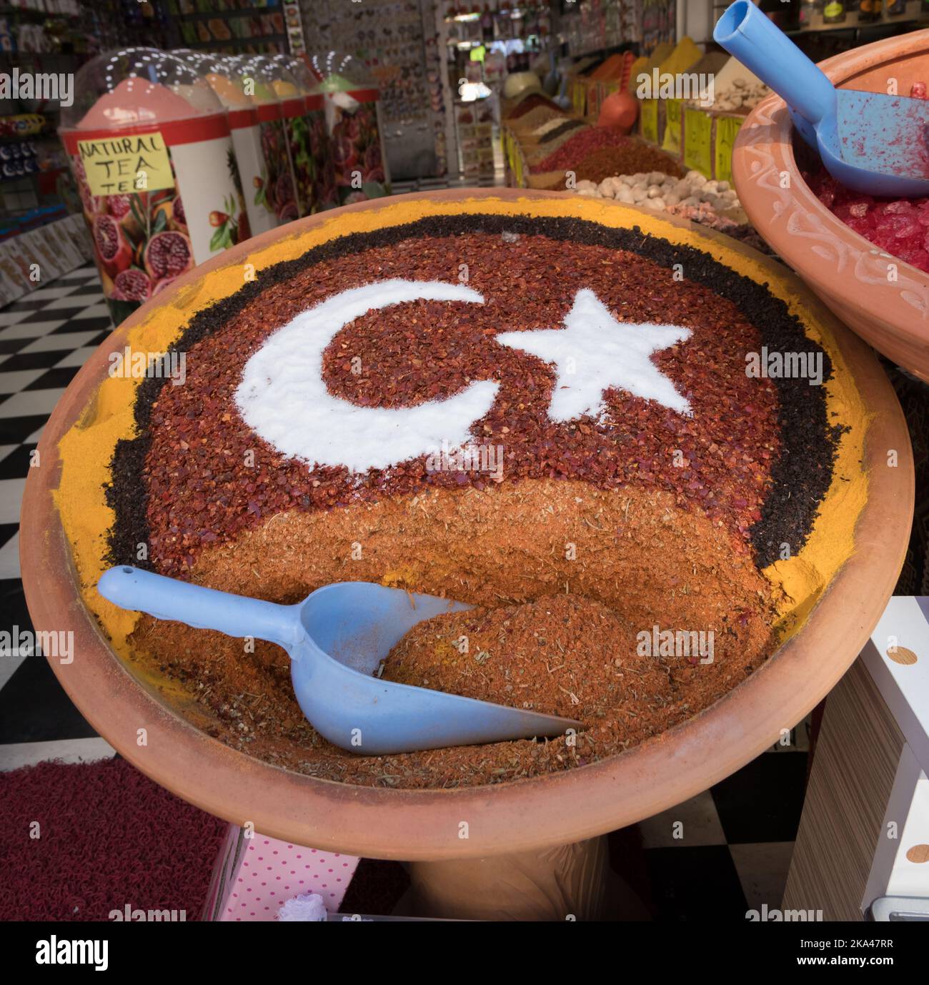 A closeup of a big clay pot of condiments in the market forming the Turkish flag of a moon and a star Stock Photo