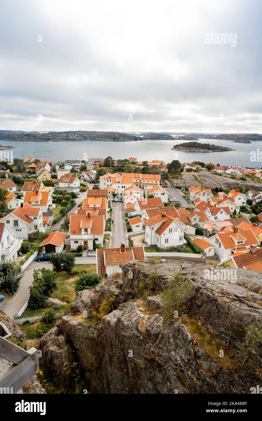 A vertical shot from a high rocky viewpoint of a small houses by the ...
