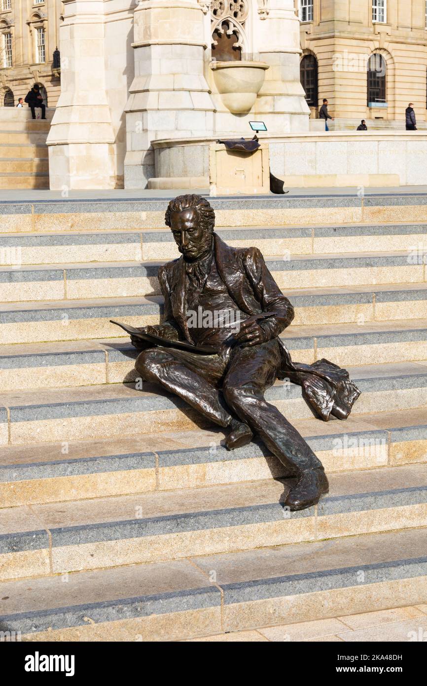 Bronze statue of Economist, Banker and Member of Parliament, Sir Thomas Attwood, sitting on steps at Chamberlain Square, Birmingham, Warwickshire, Wes Stock Photo