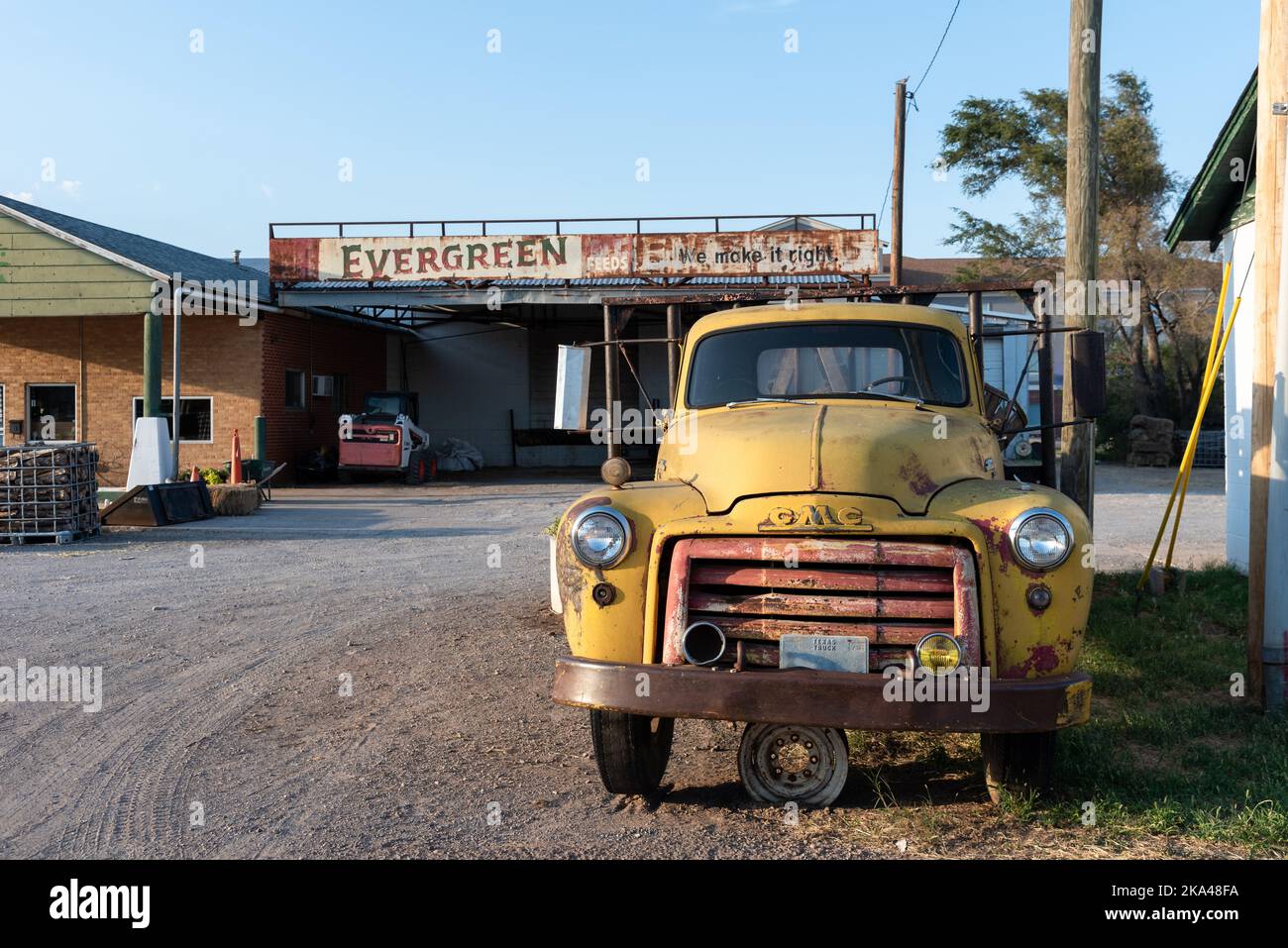 A vintage, yellow GMC truck parked in front of a business on Route 66, Shamrock, Texas, United States. Stock Photo