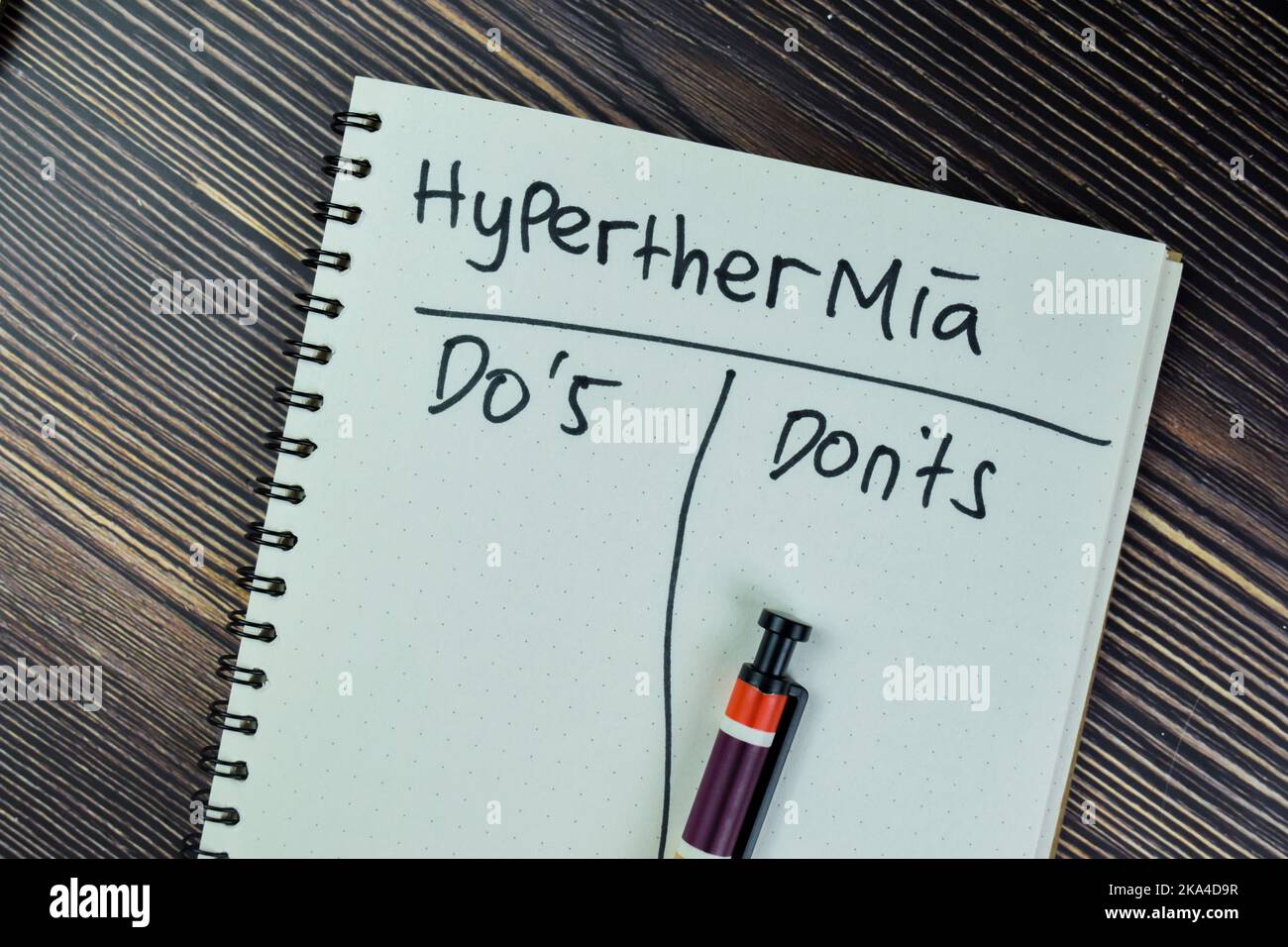 Concept of Hyperthermia write on a book isolated on Wooden Table. Stock Photo