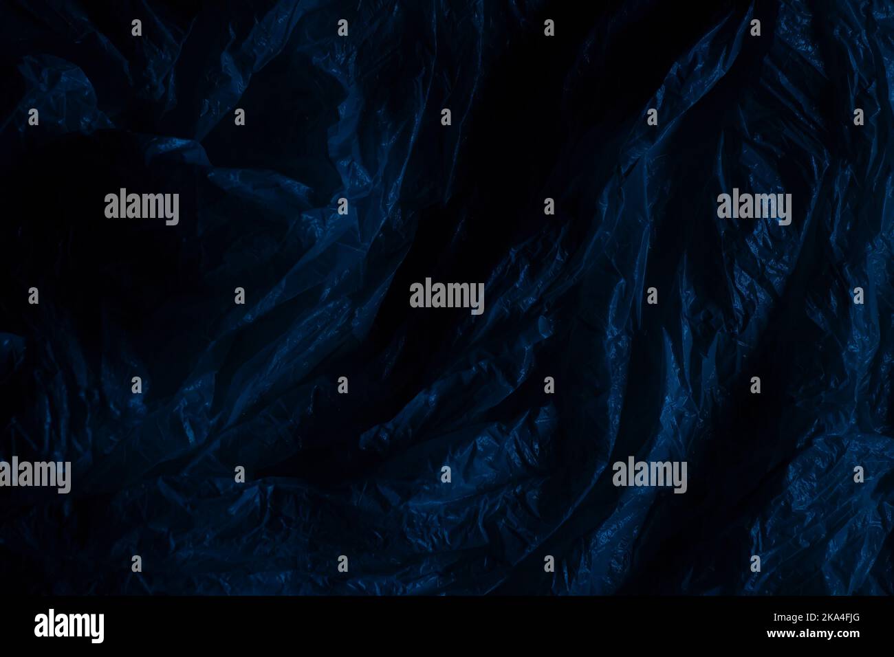 Dark plastic wrap background. Crumpled wrinkled plastic cellophane. Texture overlay effect template Stock Photo