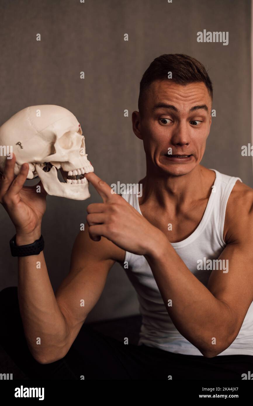 A white skull in the hands of a man. Anatomy Stock Photo Alamy