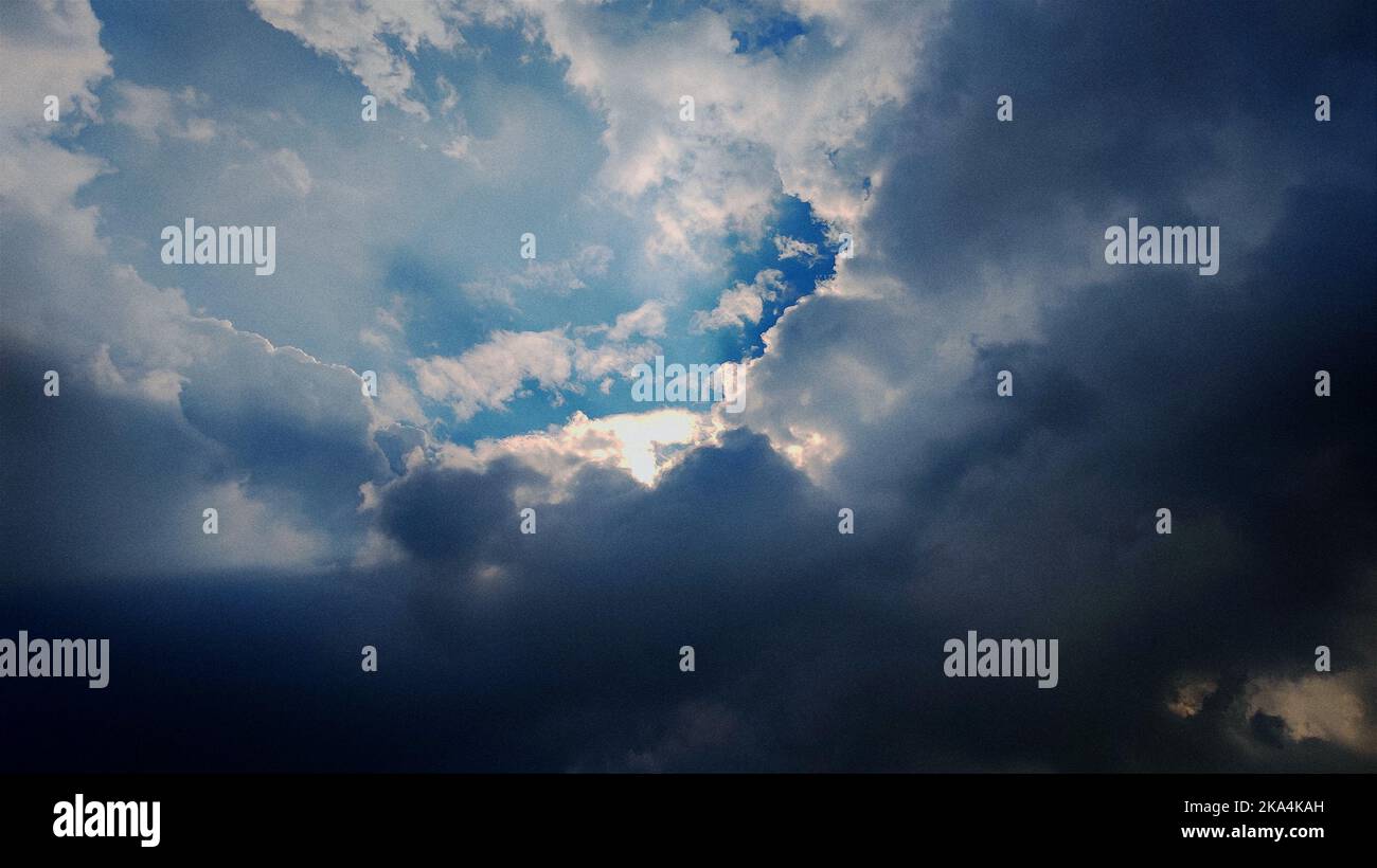 A low angle shot of dark blue sky with big clouds Stock Photo - Alamy