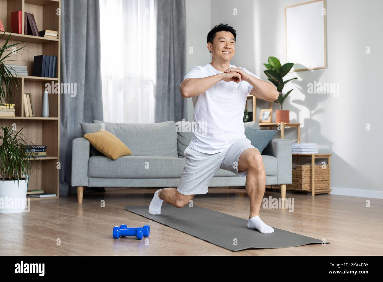 Athletic asian man training alone at home Stock Photo