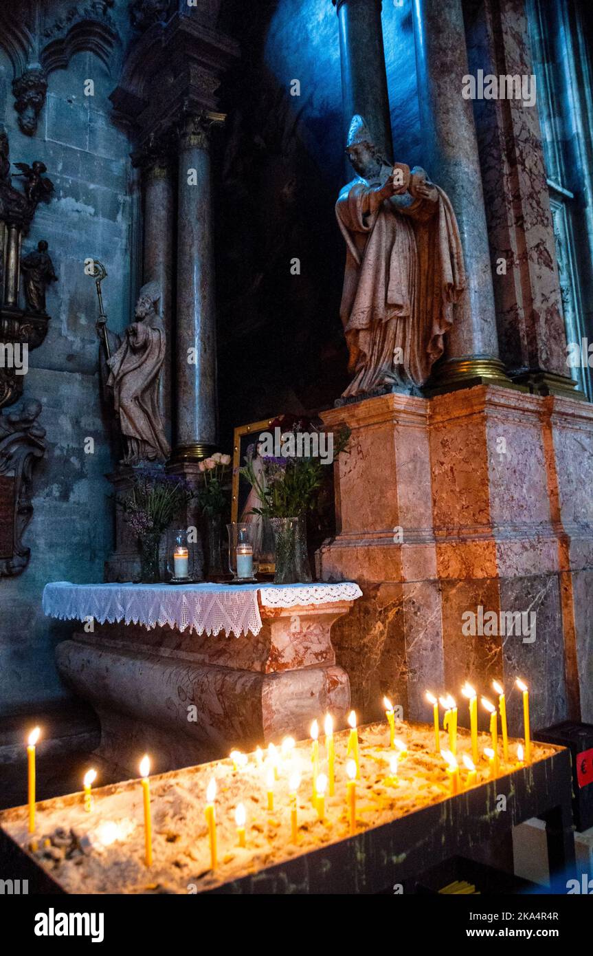 Candles to light for prayers at a small Romanesque style altar St