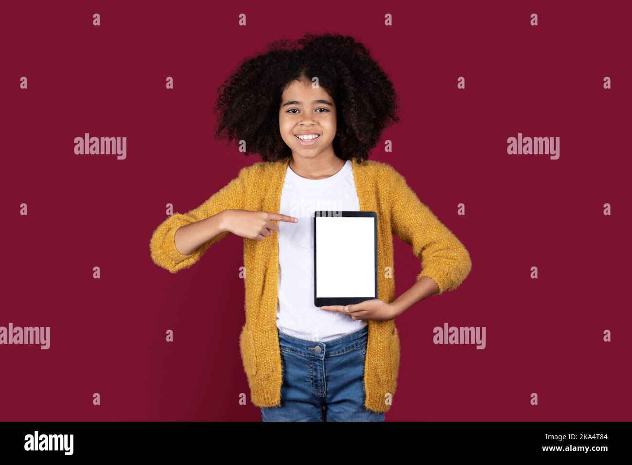 Cool black girl pointing at digital pad empty screen, mockup Stock ...