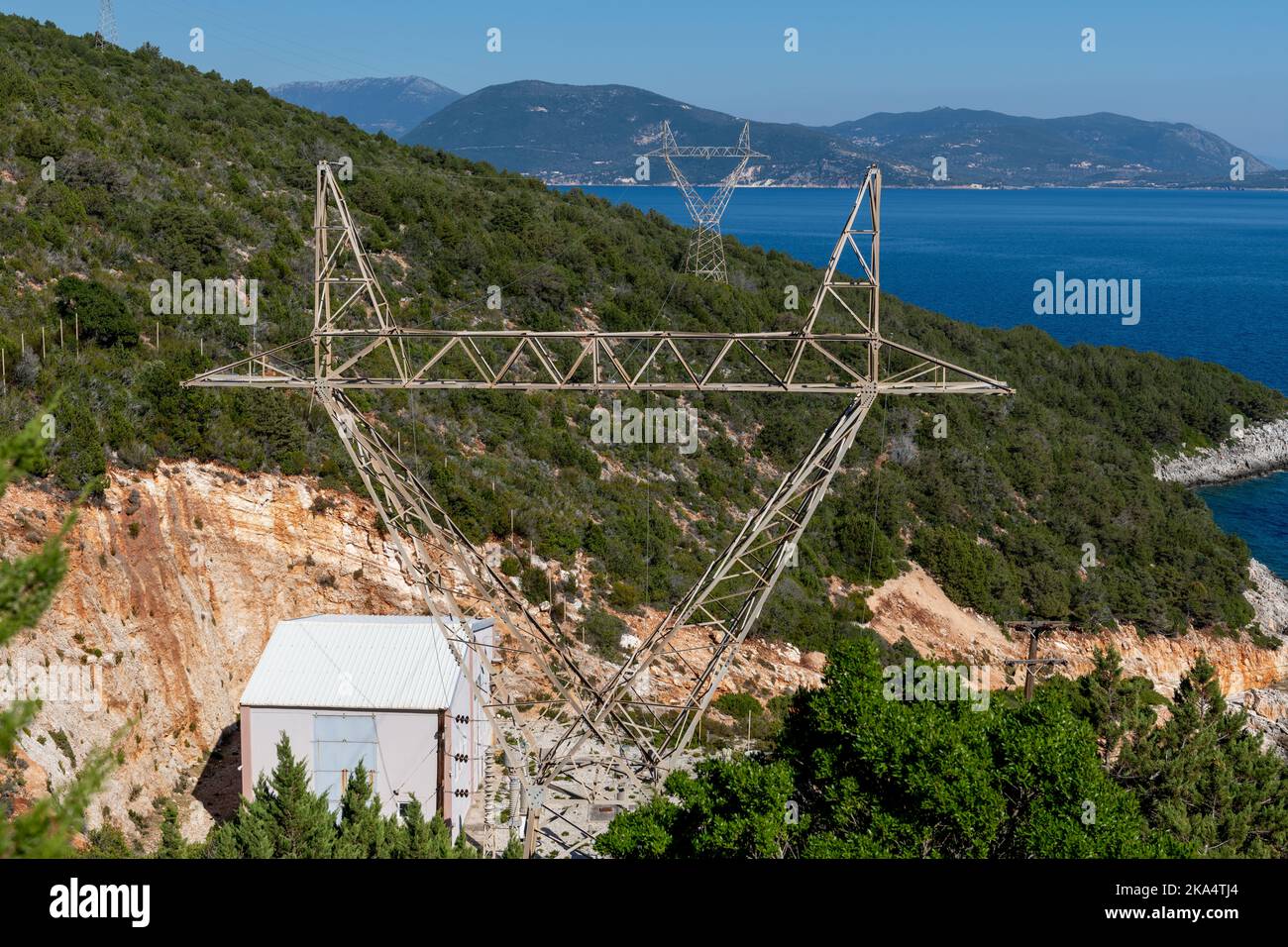 Electricity transmission tower, pylons near the sea. Stock Photo