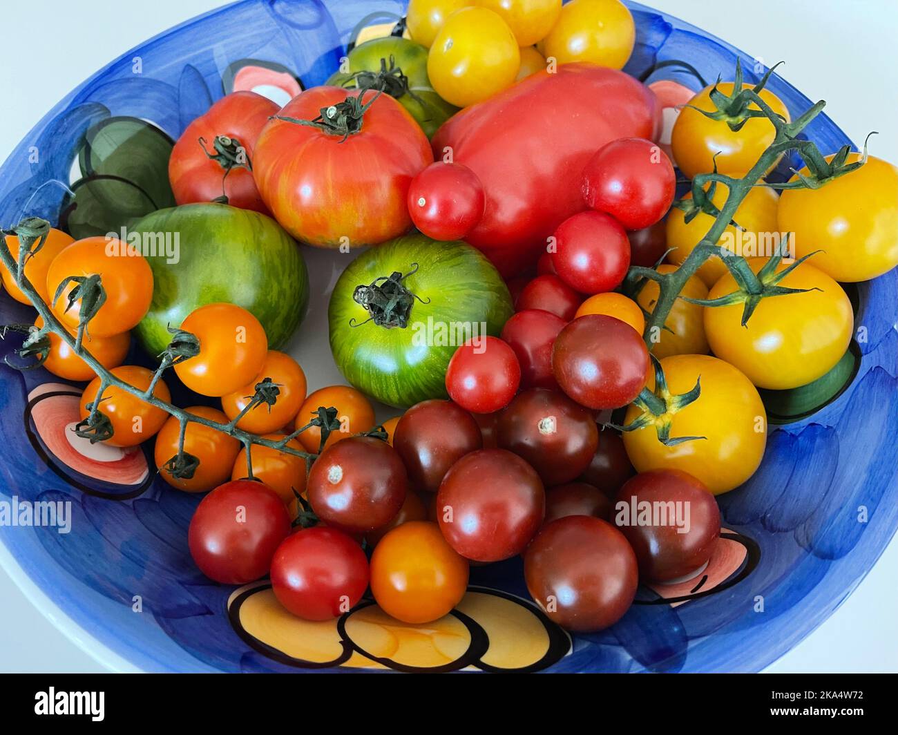 Close-Up of a bowl of assorted multi coloured tomatoes Stock Photo