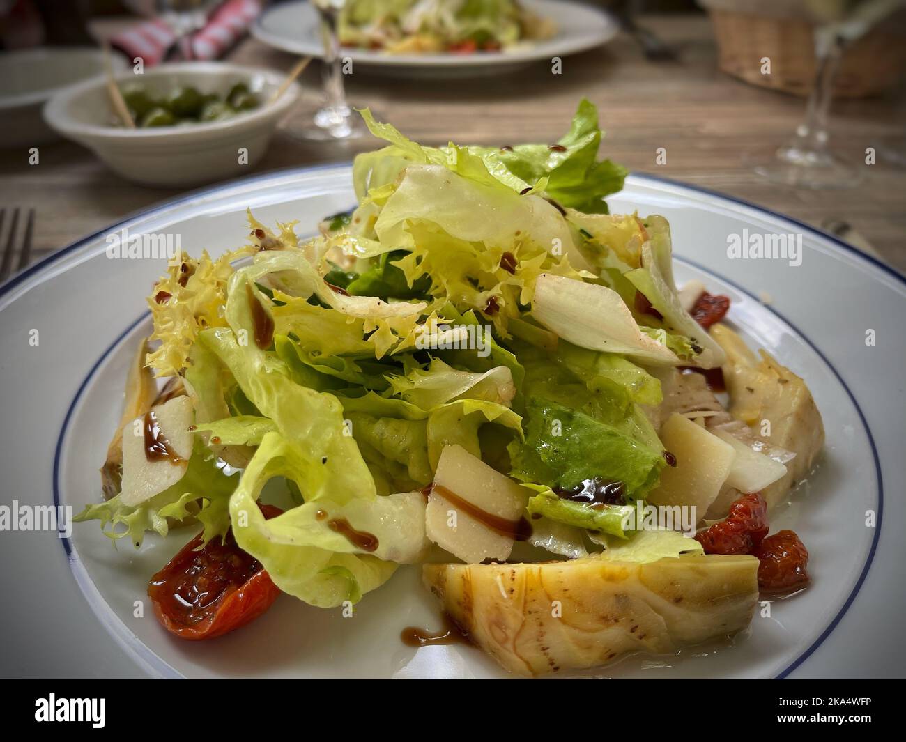 Close-up of a salad with sunblush tomatoes, artichokes and parmesan cheese Stock Photo