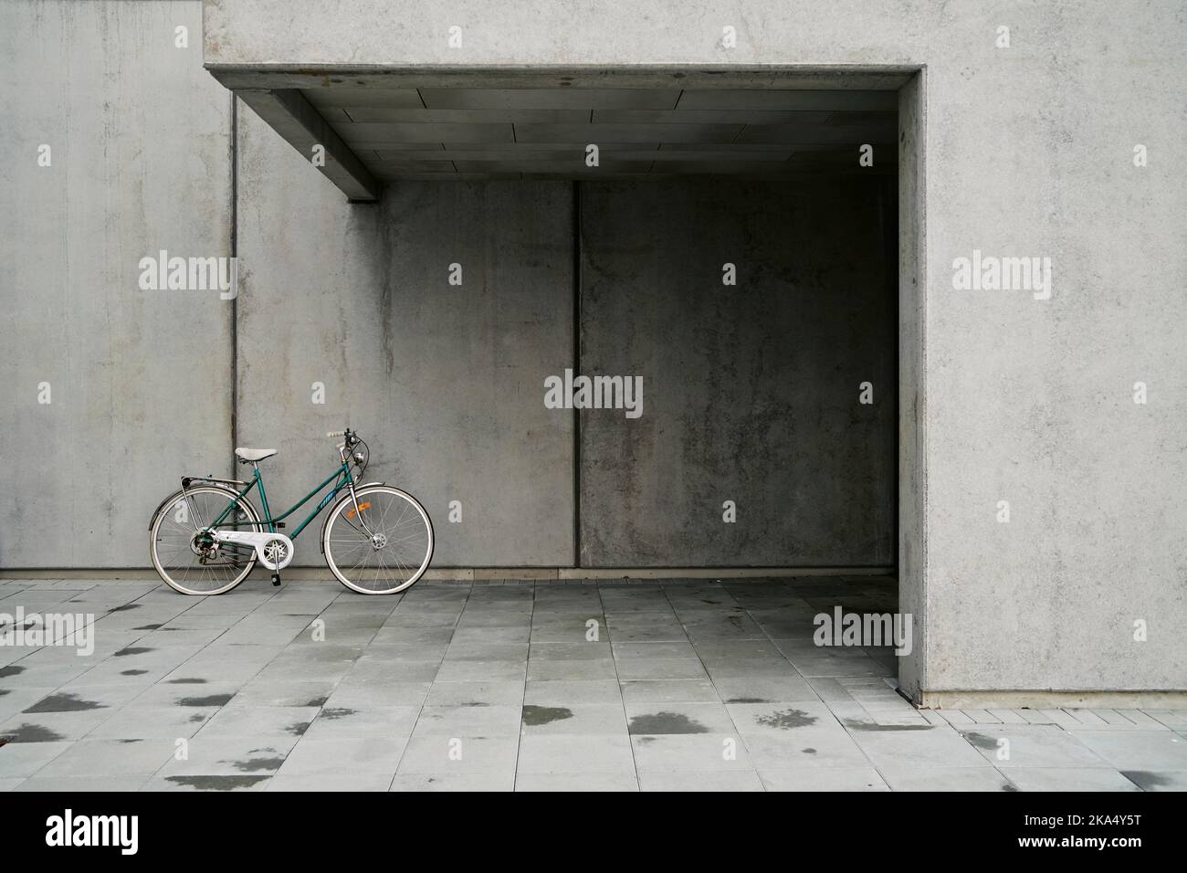 Bicycle parked near entrance of modern building Stock Photo