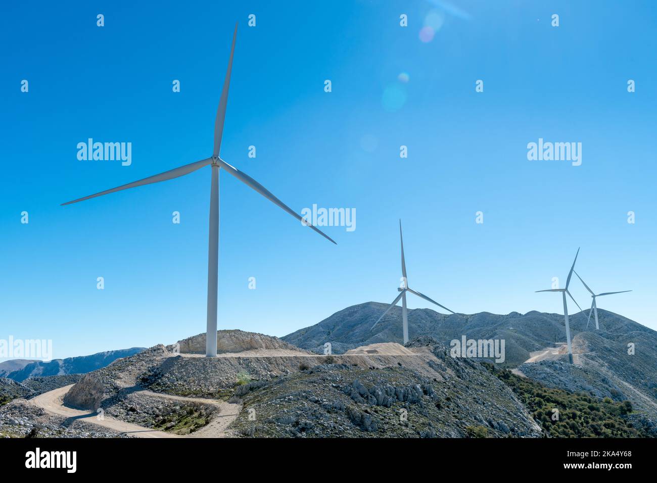 Wind turbines of a wind farm situated on a mountain top. Stock Photo