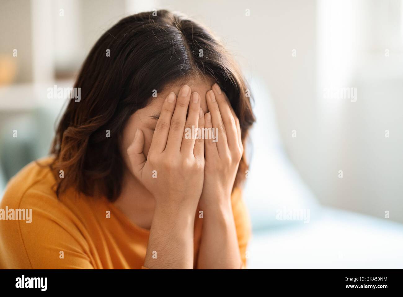 Mental Breakdown. Closeup Portrait Of Young Female Crying In Home Interior Stock Photo