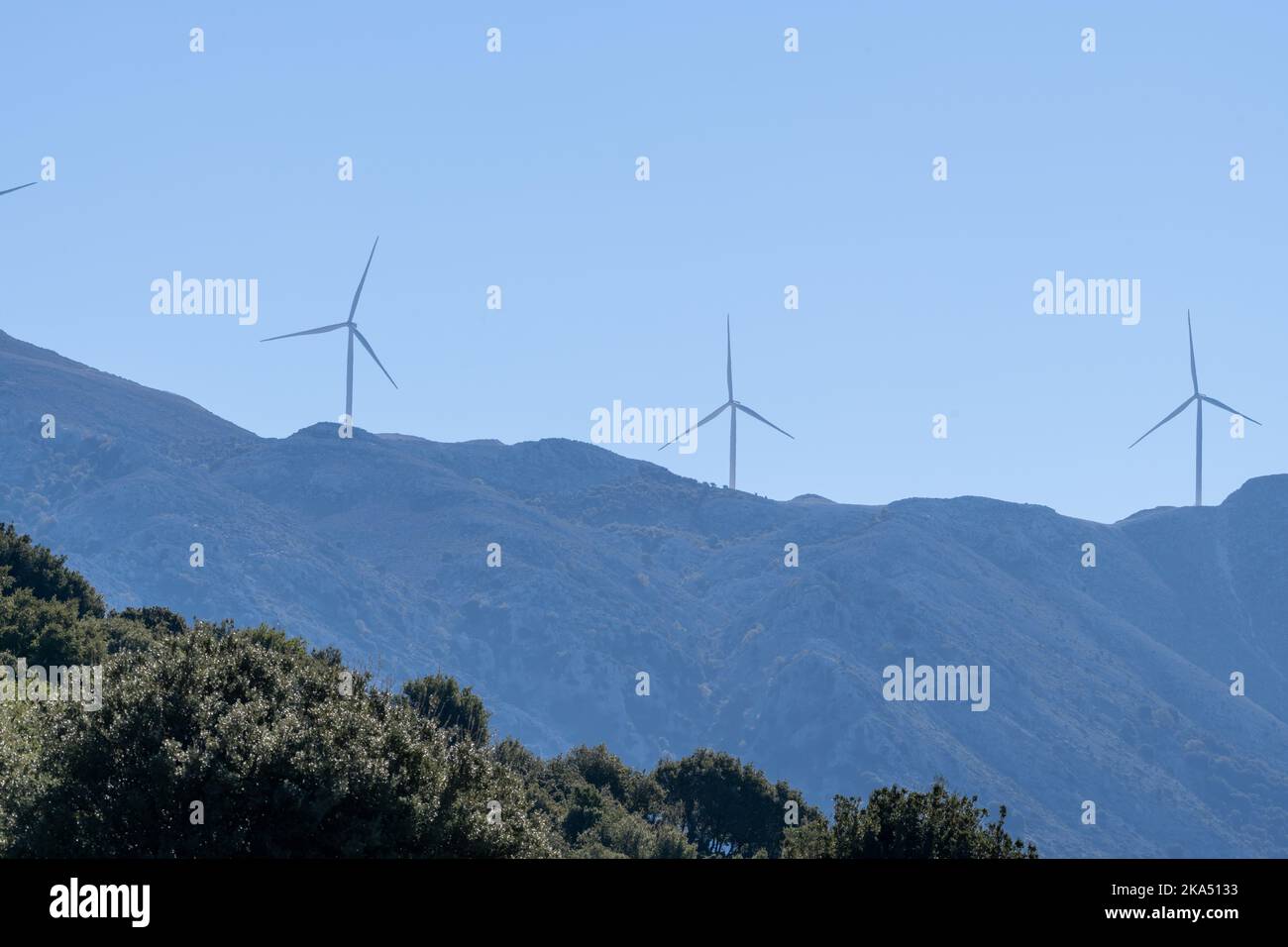 A distance view of wind turbines on a mountain top. Stock Photo