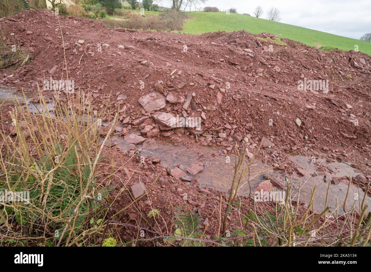Farmer has reprofiled watercourse releasing sediment into stream causing pollution Stock Photo