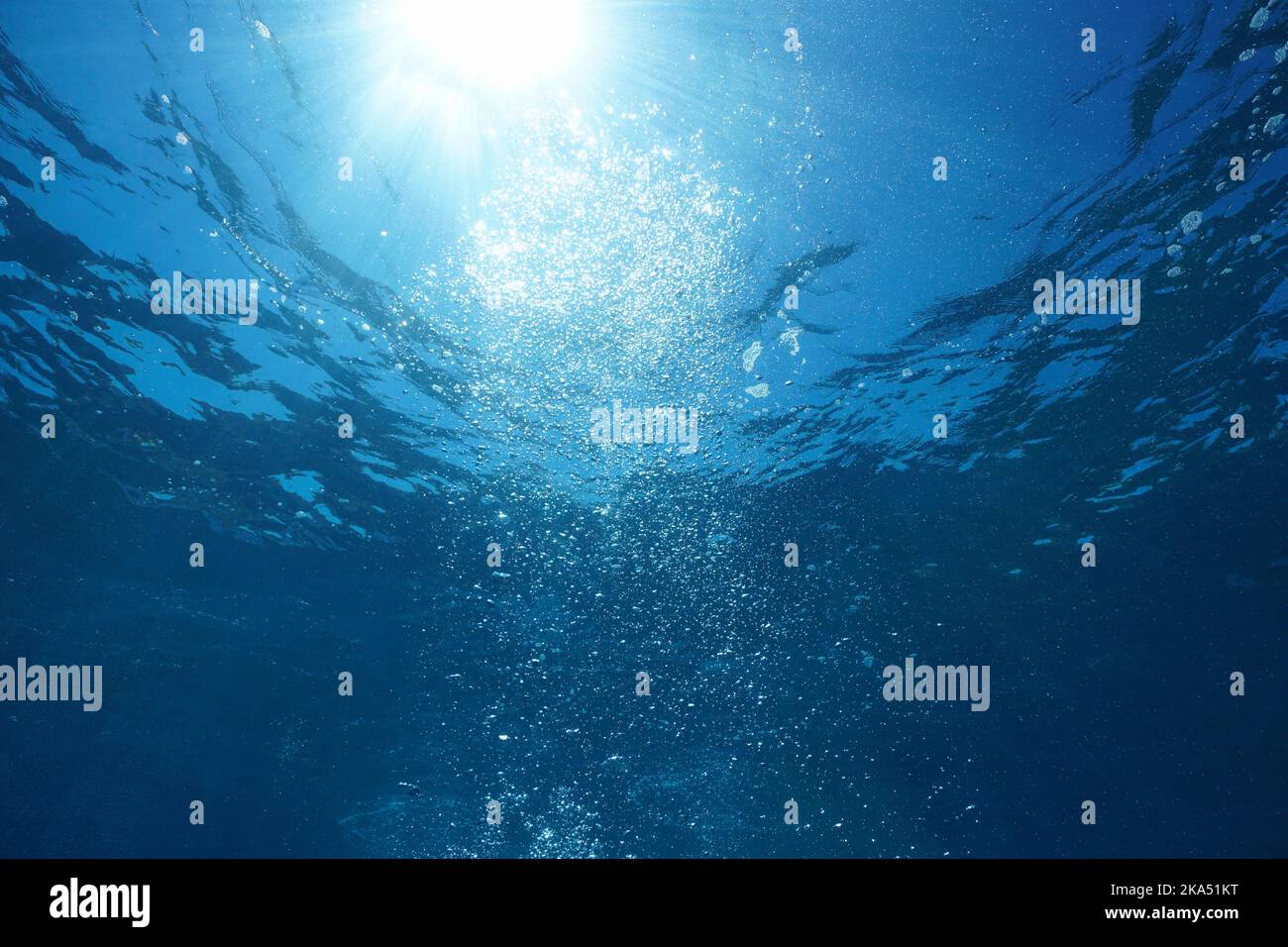 Sunlight with bubbles underwater rising to water surface, natural scene, Pacific ocean Stock Photo