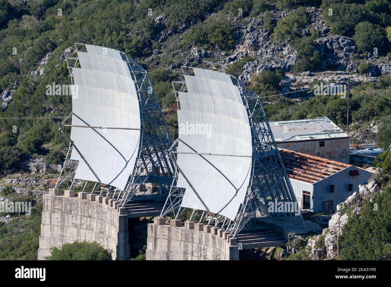 A old abandoned radar station on a mountain top with broken radar dishes. Stock Photo