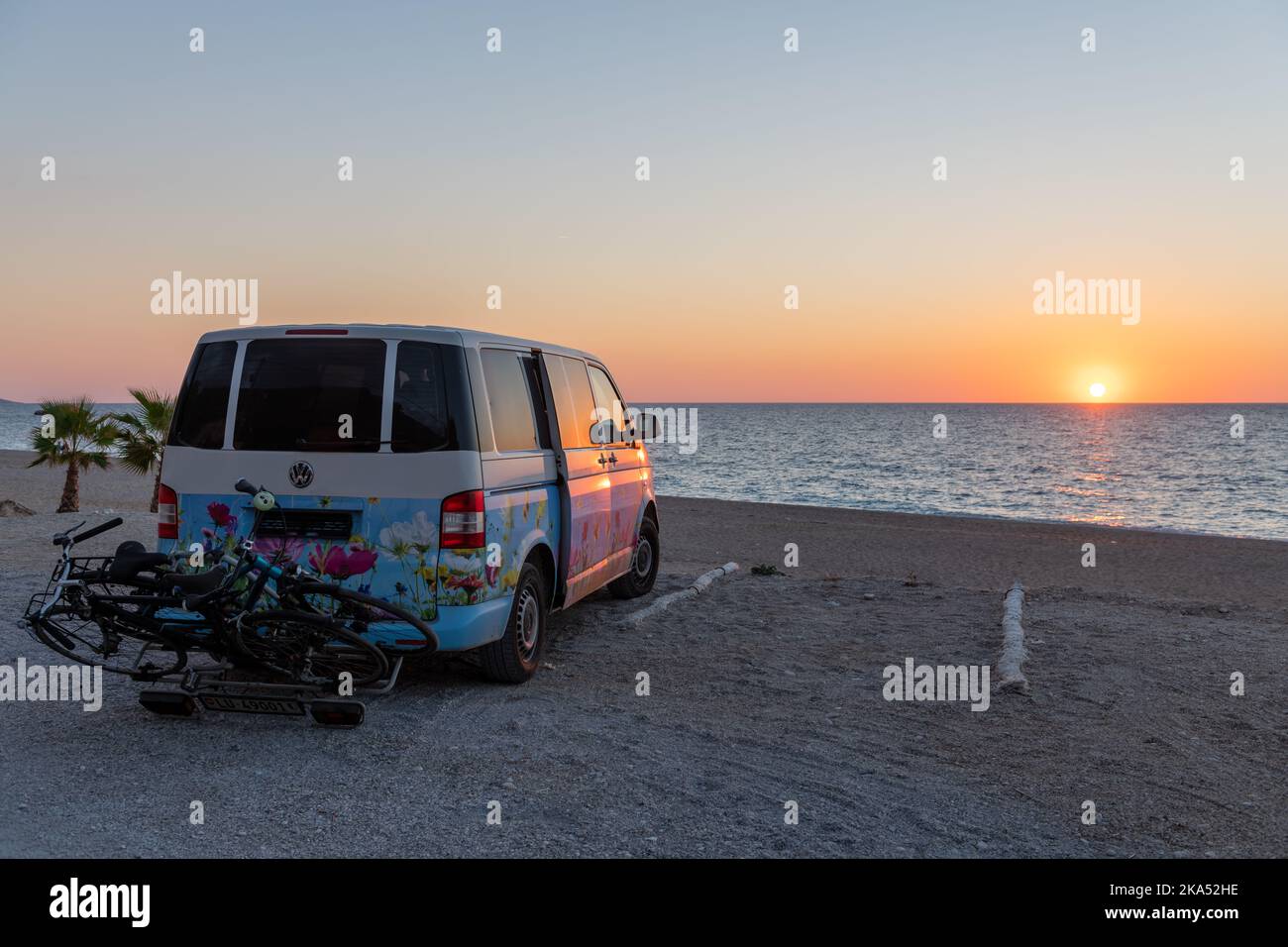 Lefkada island. Greece-10.17.2022. A camper van parked on a beach with a stunning sunset view. Stock Photo