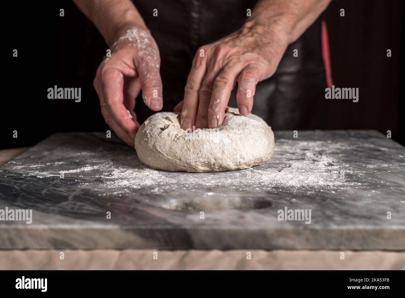 Man preparing pizza, dough on marble table. Stock Photo