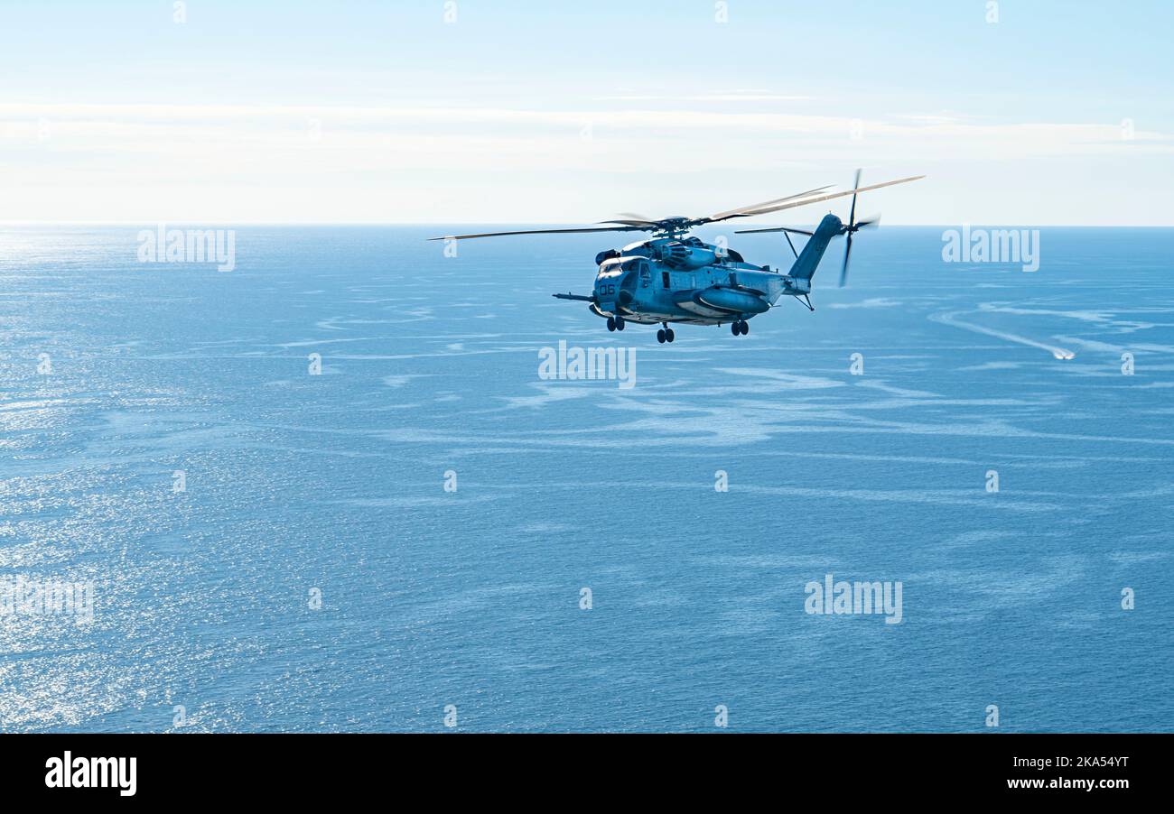 A CH-53E Super Stallion assigned to Heavy Marine Helicopter Training Unit 302, Marine Corps Station New River, North Carolina, flies over the Gulf of Mexico during a training exercise, Oct. 25, 2022. The CH-53E can carry a 26,000 pound light armored vehicle or 16 tons of cargo for 100 miles. The helicopter is compact enough to deploy on amphibious assault ships and has the armament, speed and agility to qualify as much more than a heavy lifter. (U.S. Air Force Airman 1st Class Lauren Cobin) Stock Photo