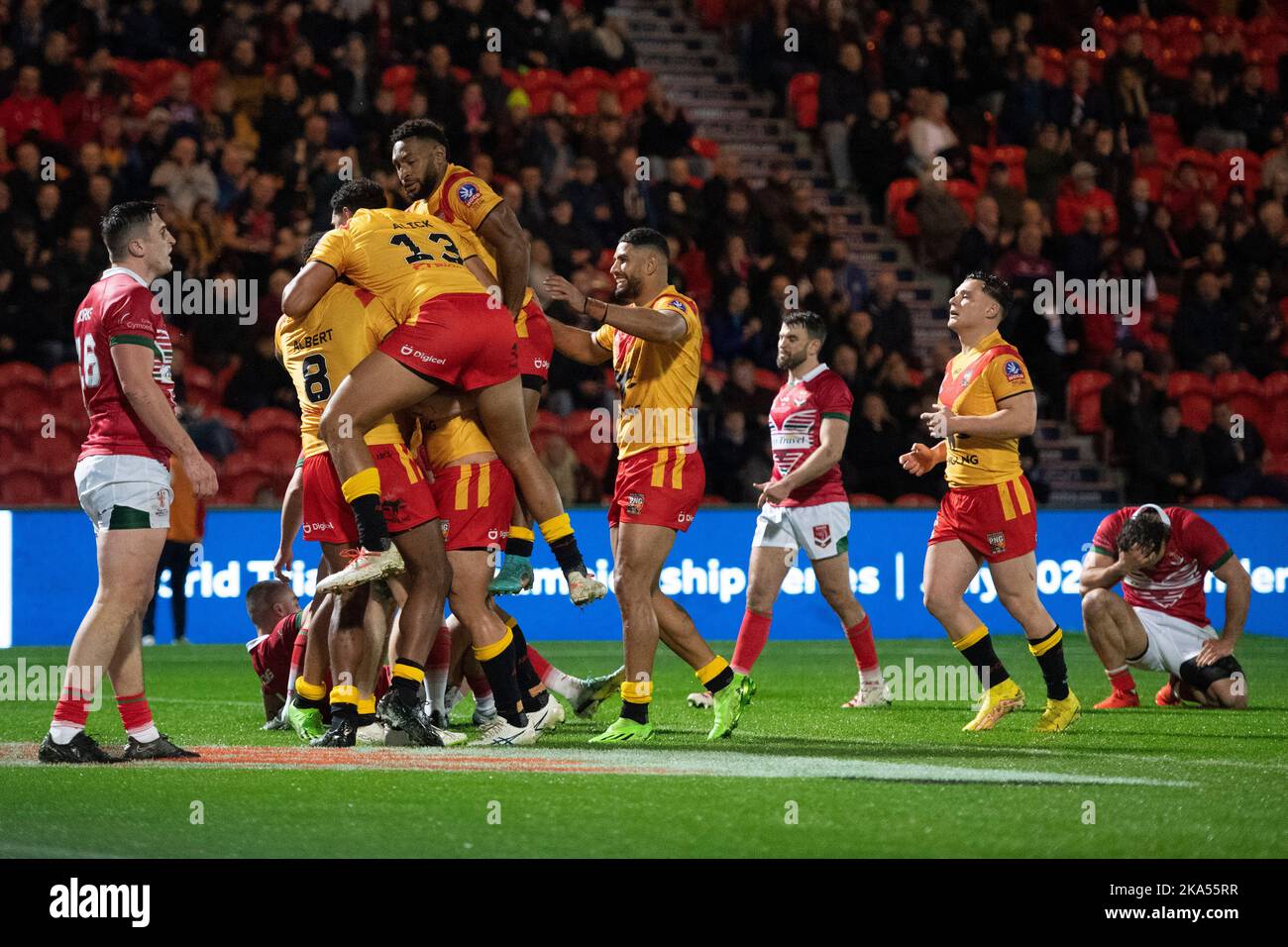 Papua New Guinea players celebrate a try from 2nd Row Nixon Putt during the 2021 Rugby League World Cup Pool D match between Papua New Guinea and Wales at the Eco-Power Stadium,