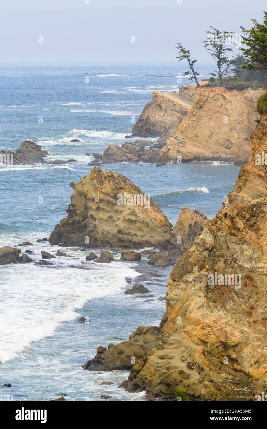 Rugged cliffs against the Pacific Ocean at Cape Arago Oregon Stock Photo