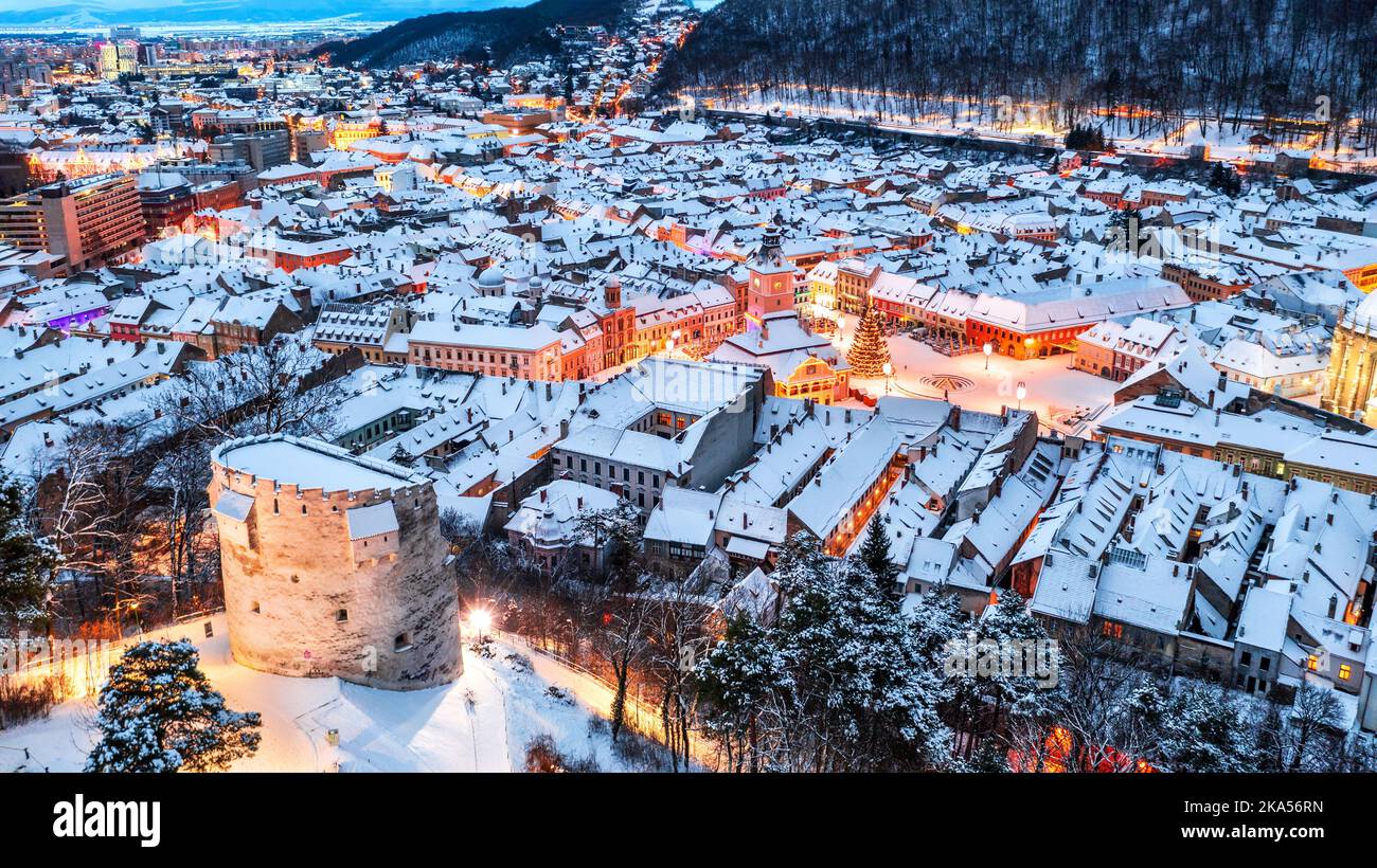 Brasov, Romania. Winter Christmas drone view of White Tower, Council Square and Christmas Tree, Transylvania landmark in Eastern Europe. Stock Photo