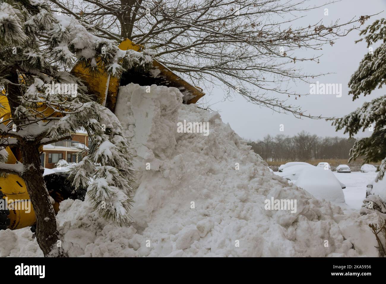 Cleanup of snow with tractor after large snowfall snowstorm in winter ...