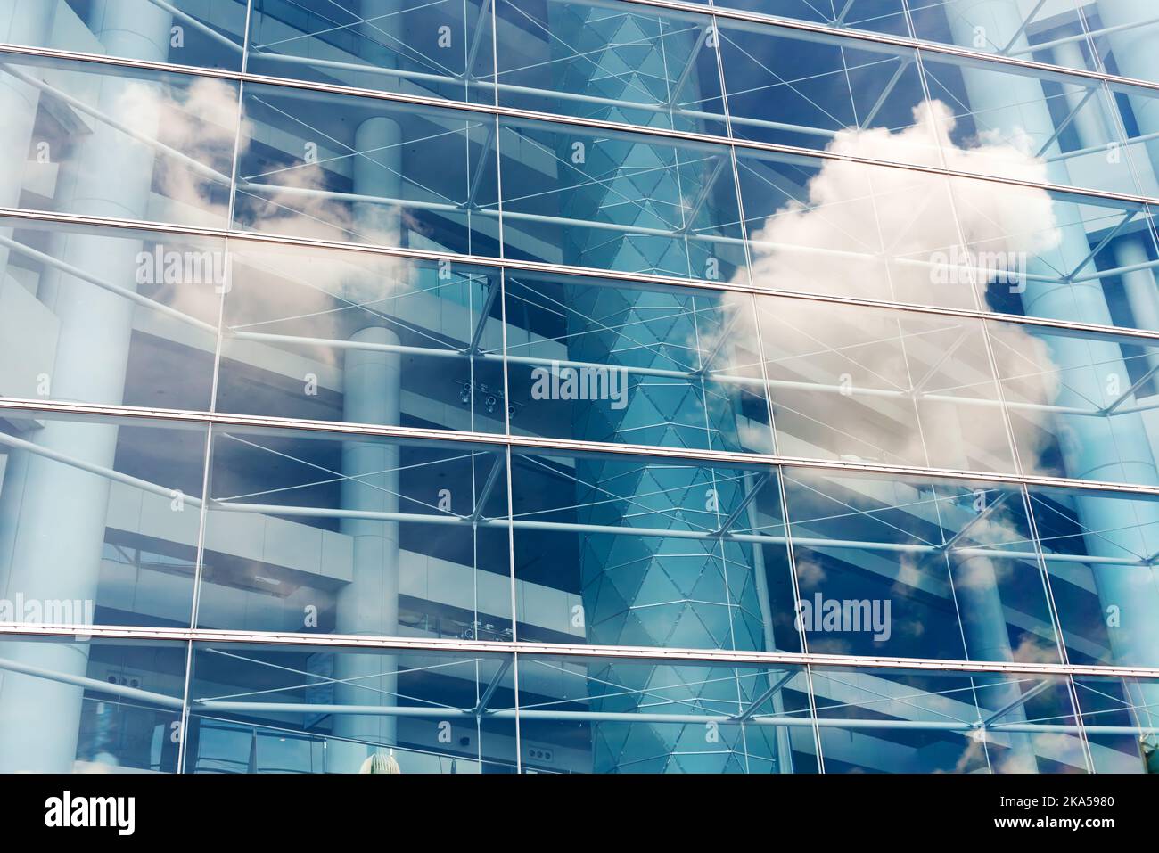 Clouds reflected in windows of modern office building Stock Photo - Alamy