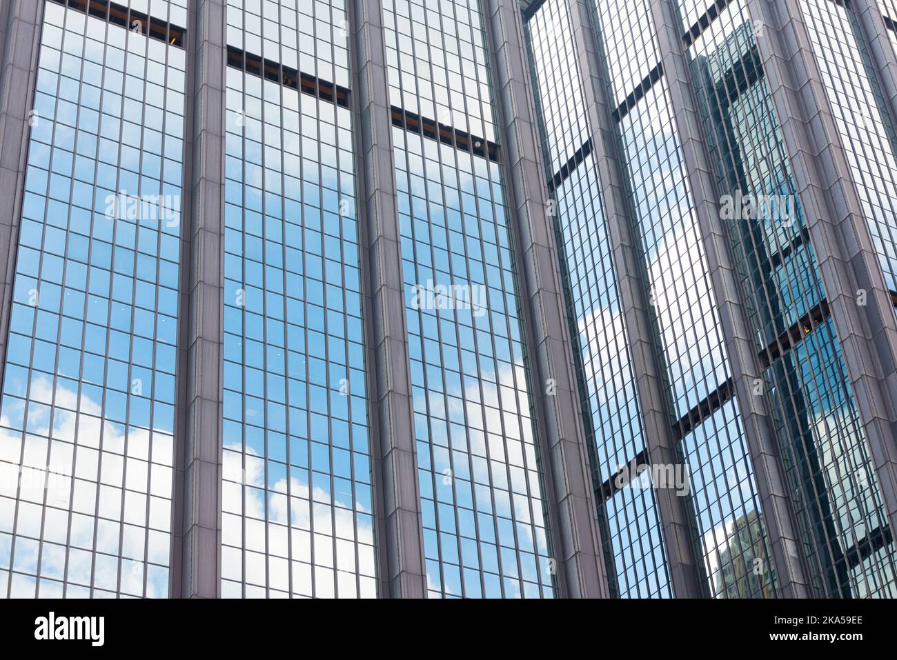 Clouds reflected in windows of modern office building Stock Photo - Alamy