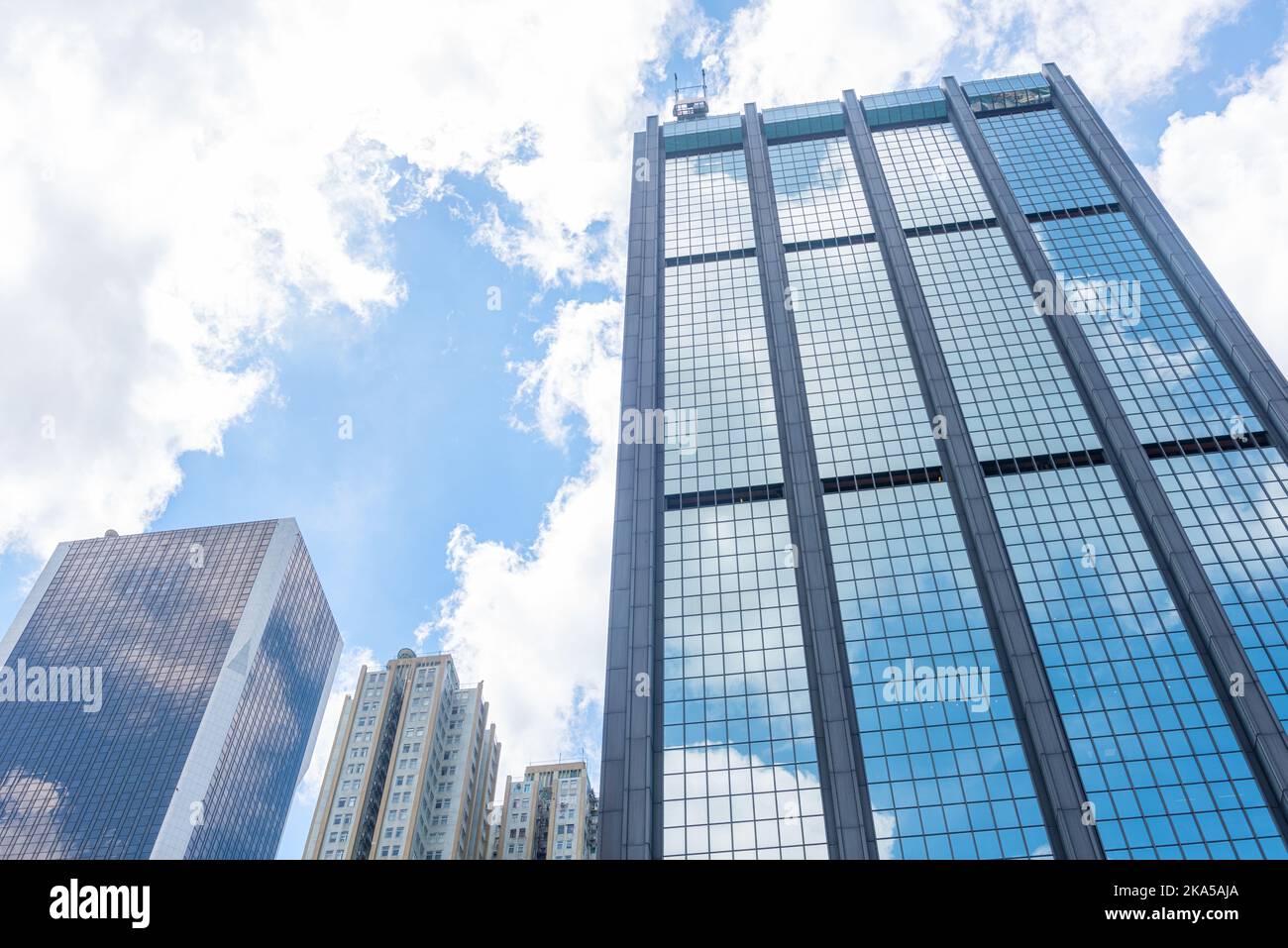 Clouds reflected in windows of modern office building Stock Photo - Alamy
