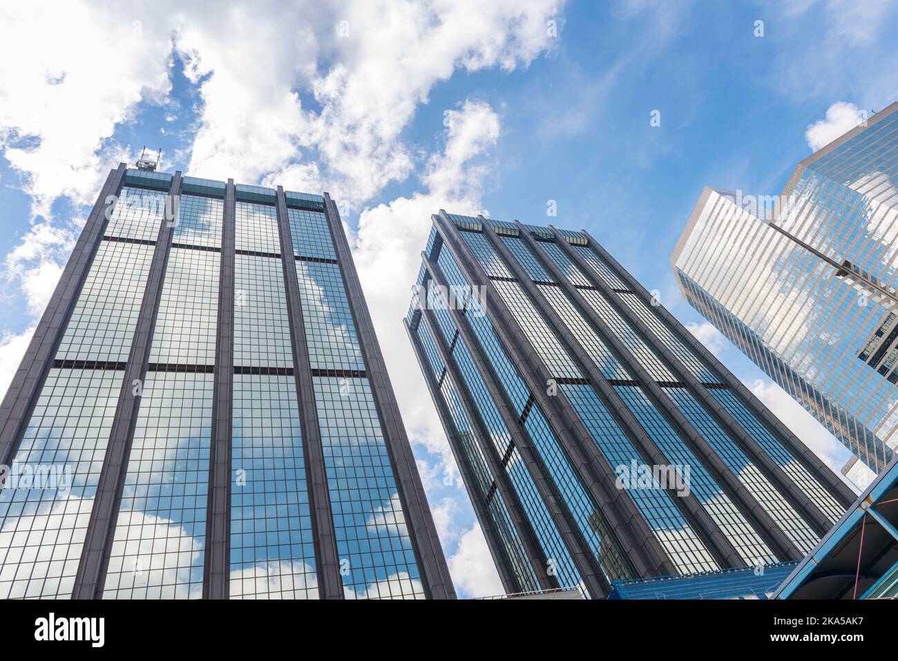 Clouds reflected in windows of modern office building Stock Photo - Alamy