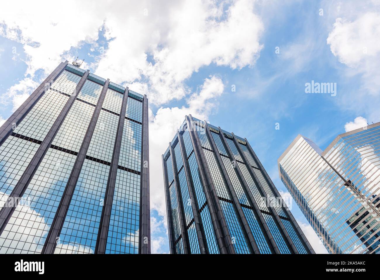 Clouds reflected in windows of modern office building Stock Photo - Alamy