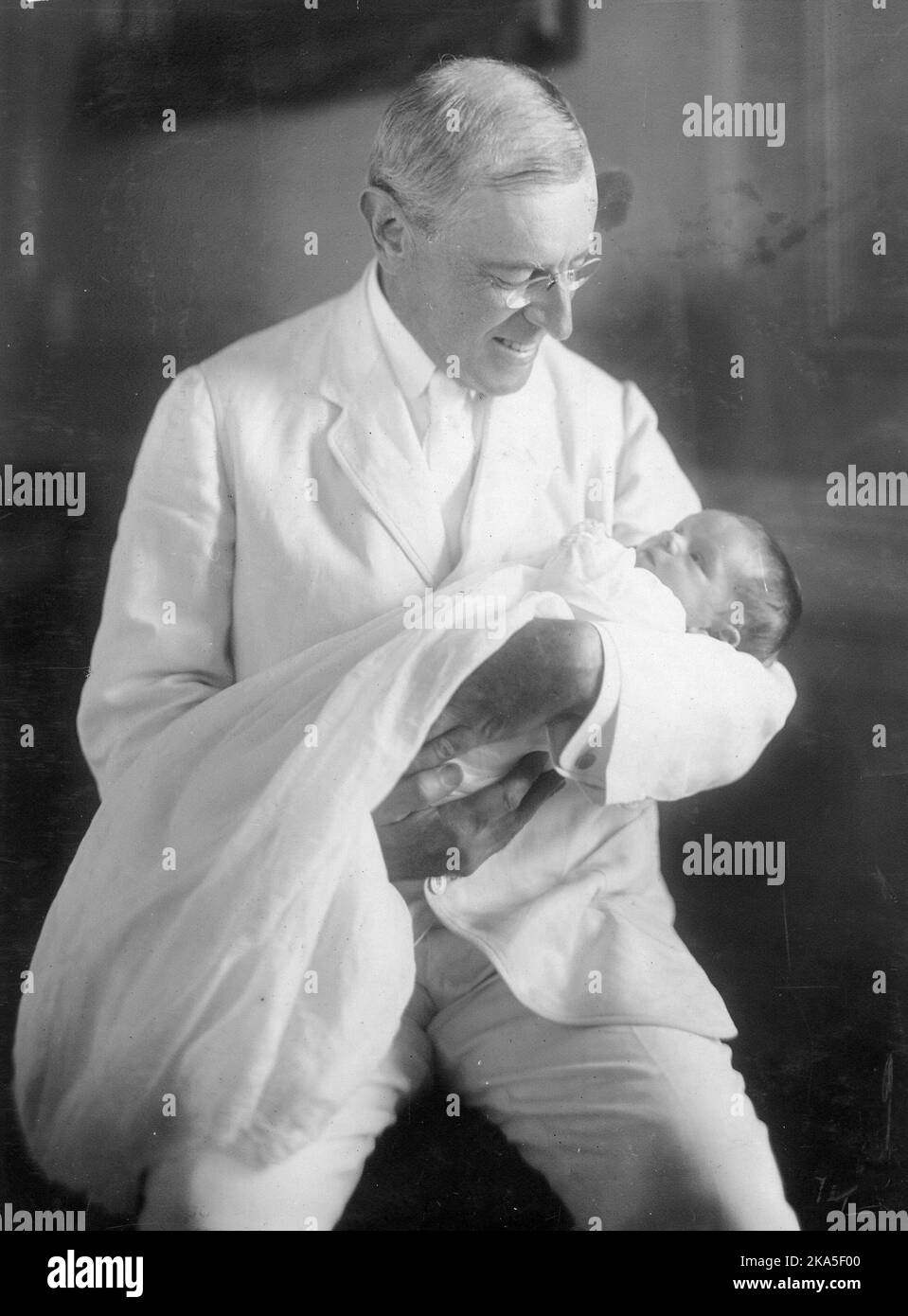 Photograph of President Wilson with his newly born granddaughter, Ellen Wilson McAdoo. Stock Photo
