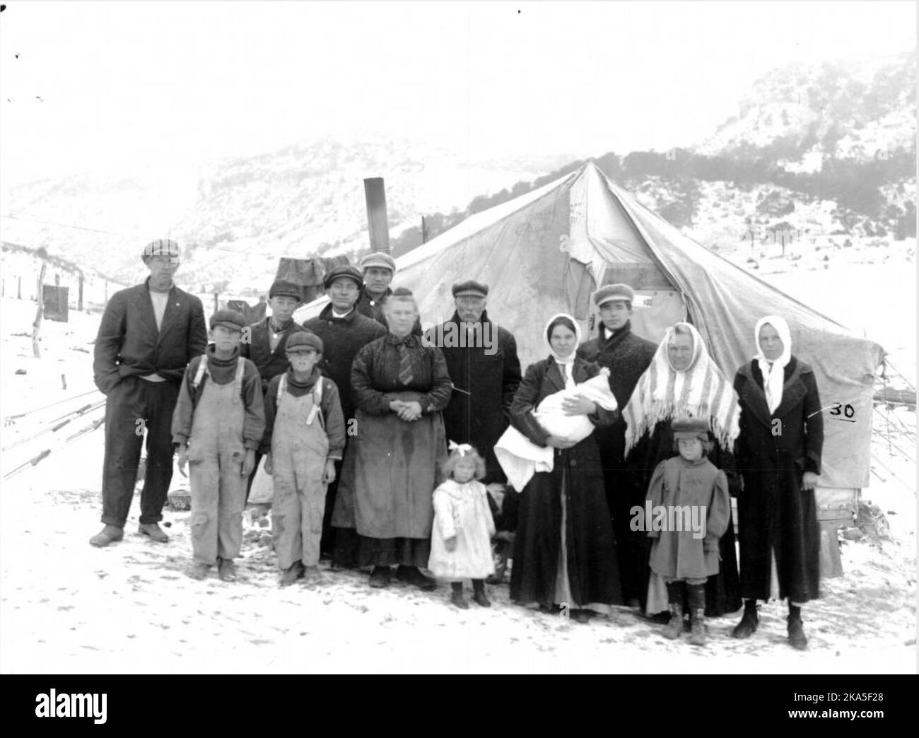 UMWA strikers at the Forbes Colony, 1914. After the 10 March destruction of the colony, Joseph Zanetell (light cap, in front of chimney) would lose two newborn twins to exposure Stock Photo